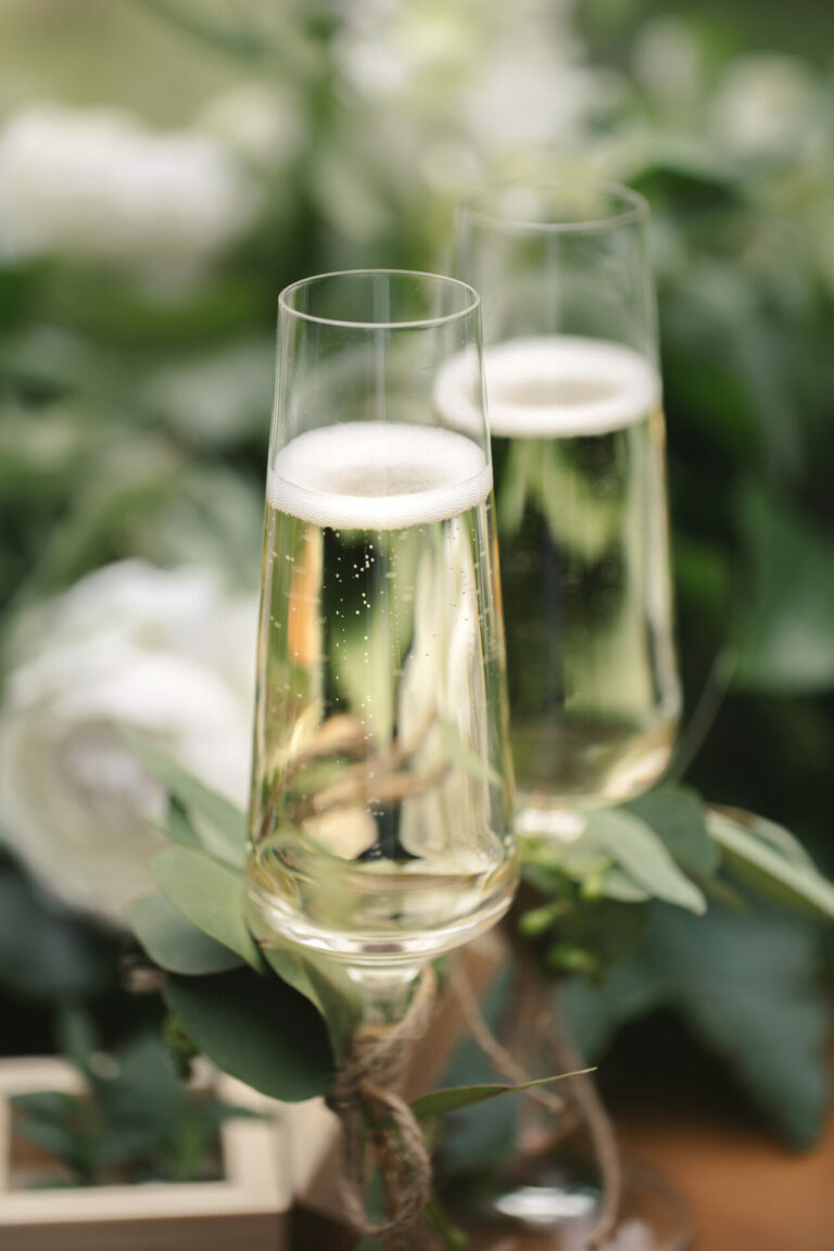 Champagne glasses on a table. Book a wedding dress consultation at Bys Vyken Bridal to find your dream wedding dress.