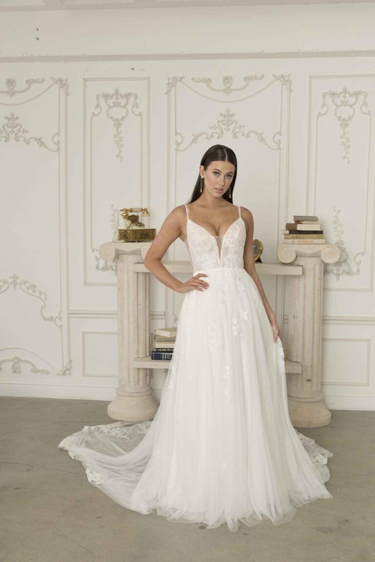 Romantic a-line blush wedding dress with floral design perfect for a barn or woodland wedding.