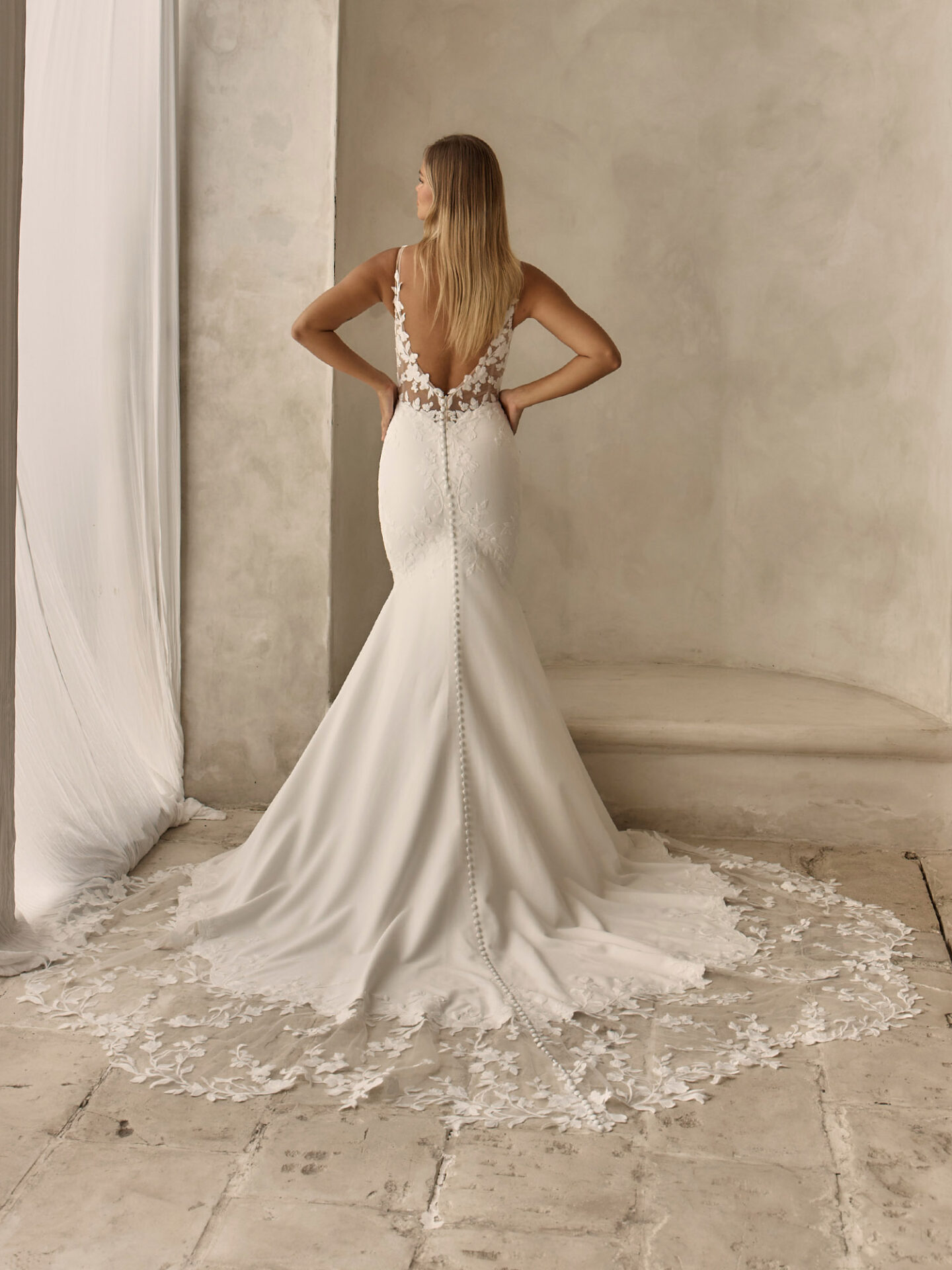 Fitted clean crepe Tai wedding dress with modern floral embroidery