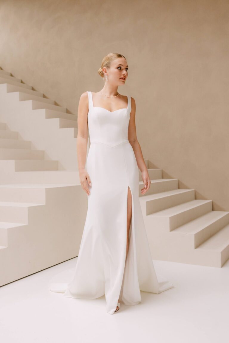 Crepe wedding dress with detachable sleeves and matching cape